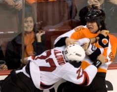 Fans react as Flyers Arron Asham tangles with Devils Pierre-Luc Letourneau-Leblond in the third period of Sunday's game at Philadelphia. 3/28/10